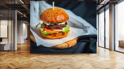 Freshly made forest burger with rucola, onions, grilled portobello and garlic souce on dark background Wall mural