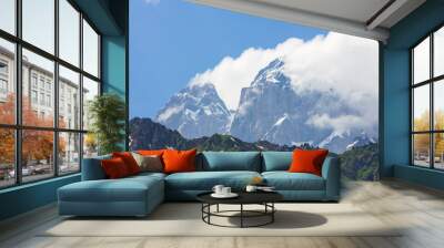 peak of mountain Ushba with cloud in sunny day Wall mural