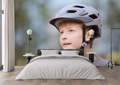 kid putting bike helmet on Wall mural