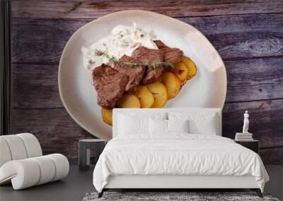 Thick juicy portions of grilled beef fillet with mushroom sauce served with thyme potatoes Wall mural