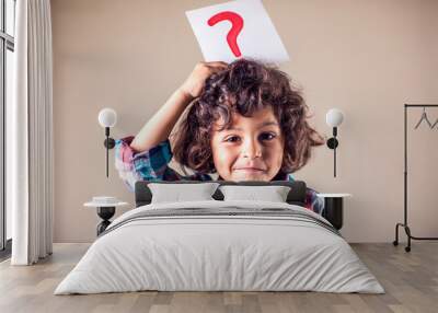 Kid boy with question mark. Children, education and emotions concept Wall mural