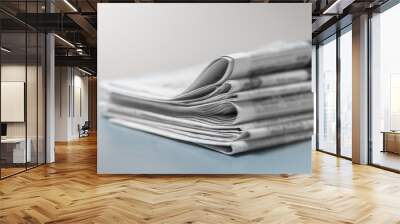 Pile of fresh morning newspapers on the table at office. Latest financial and business news in daily paper. Pages with information. Wall mural