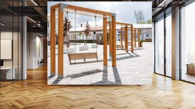 Outdoor swings of modern design, a town square, a place of rest for citizens, wooden benches, swinging on chains, an amusement park. Wall mural