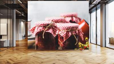 Homemade strawberry jam in jars and inredients on a wooden cutting board Wall mural