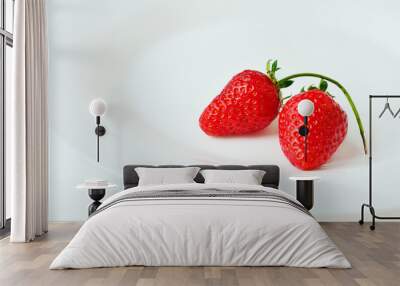 Two red strawberries on a white plate. Strawberries on white background  Wall mural