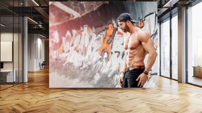 Handsome man posing in front of Graffiti wall Wall mural