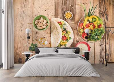 Delicious tortilla wraps on wooden table with vegetable Wall mural