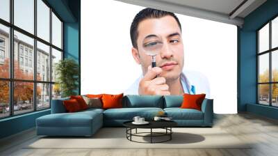 young amazed man looking with magnifer, isolated on white backgr Wall mural