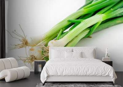 A bunch of fresh green onions placed on a clean white surface Wall mural