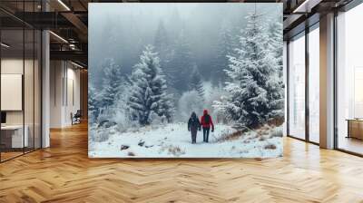 A couple in red jackets walking in the solitude of a snow-covered forest, the trees heavy with winter's touch Represents companionship in serenity. Wall mural