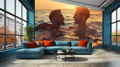 A romantic moment between a couple in the ocean as the sun sets in the background Wall mural