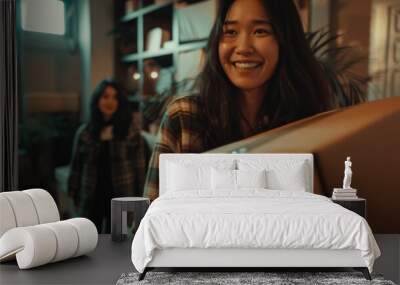 A woman stands in a cozy living room, holding a box with an uncertain expression Wall mural