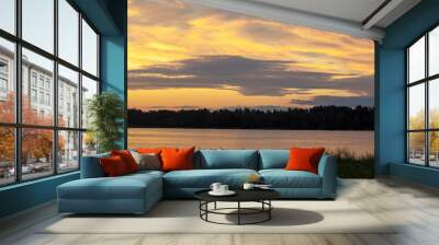 Beautiful colors of sunset on a warm summer evening over the lake. Beauty in nature. Calm and beautiful evening landscape. Wall mural