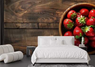 Beautifully arranged ripe strawberries in a rustic bowl on a wooden table, depicting healthy and natural food. Wall mural