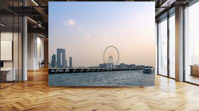 DUBAI, UAE - May 1, 2024 : Bluewaters island with modern architecture and ferris wheel aerial. Yacht floating near and residential area near Dubai marina and JBR area. Wall mural