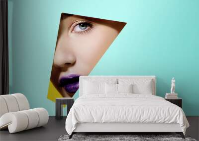 Plump bright purple lips in turquoise paper frame. Young model face. Close up beauty portrait. Geometry and minimalism. Creative fashion makeup, beautiful woman Wall mural