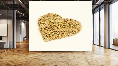 Heart shaped peeled seeds on white background Wall mural