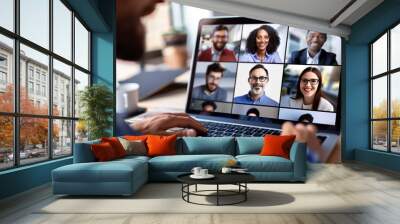 Online meeting with colleagues' faces in a grid on a laptop, captured in a clean, light workspace.

 Wall mural