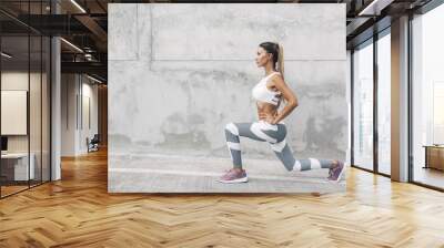 Fitness sport woman in fashion sportswear doing workout over gray wall Wall mural