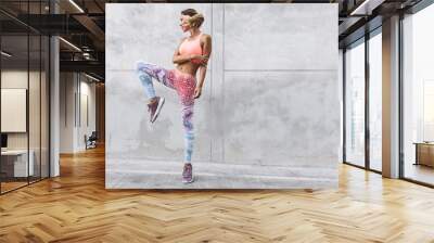 Fitness sport woman in fashion sportswear doing yoga exercise over gray wall Wall mural