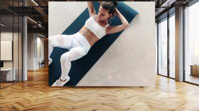 Girl wearing fashion sports wear in gym Wall mural