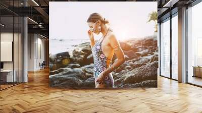 Model in ethnic monokini and wearing boho jewellery Wall mural