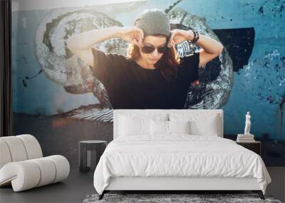 model wearing plain tshirt and sunglasses posing over street wall Wall mural