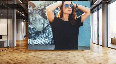 model wearing plain tshirt and sunglasses posing over street wall Wall mural