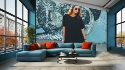 model wearing plain tshirt and sunglasses posing over street wall Wall mural