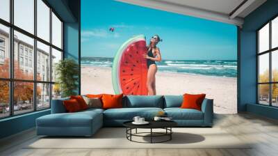 Model with watermelon lilo at the beach Wall mural