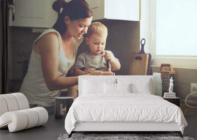 Mother with child cooking together Wall mural