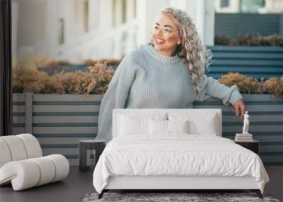 Plus size model with blond curly hair in knitted sweater outdoor Wall mural