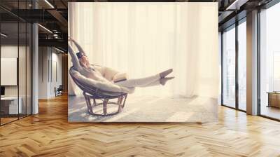 Woman relaxing in chair Wall mural