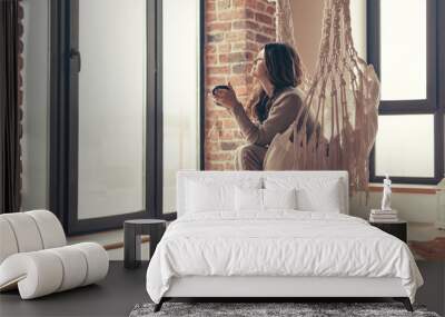 Woman wearing cashmere nightwear relaxing in cabin near fireplace Wall mural