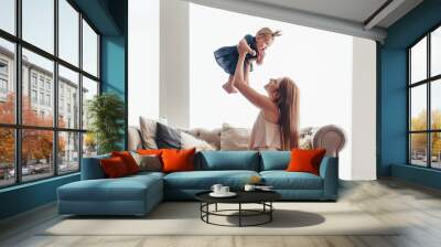 Young mom with her 8 month baby Wall mural