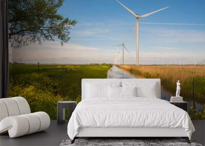 wind turbines in the field near the canal Wall mural