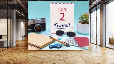 Travel planning, vacation trip - Calendar with the date 2July glasses notepad pen camera cash passports. Wall mural