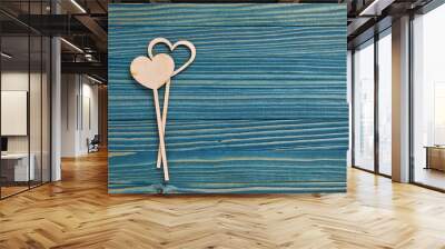 Two love hearts on a blue wooden background. Valentine's Day card concept. Flat lay composition. Wall mural