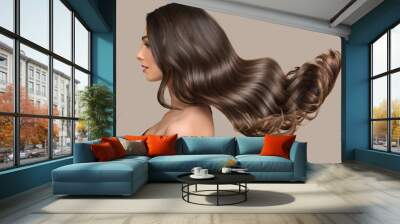 woman shiny long wavy hair up. side view. grey background Wall mural