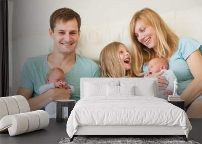 big family of 5 with older daughter and baby twins, indoor portrait at home Wall mural