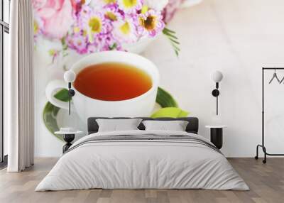 herbal tea in a cup, fresh flowers in the background, morning tea or herbal medicine concept. High quality photo created with ai generative technology Wall mural