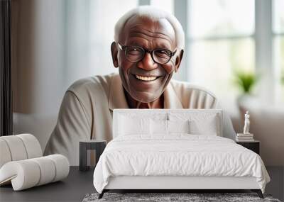 natural portrait of a senior elderly black skinned man with a gift box, blurred home interior background Wall mural