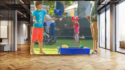 outdoor portrait of young boy playing with diabolo, chinese yo-y Wall mural