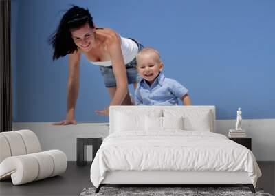 outdoor portrait of young happy mother and child on blue sky bac Wall mural