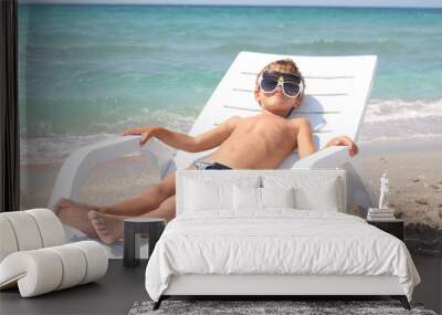 young boy relaxing on beach Wall mural