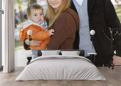 young happy family with child, outdoor portrait on natural backg Wall mural