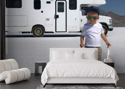 Cute kid (baby) in trendy sunglasses and white t-shirt. Motorhome (RV) on Bonneville Wall mural