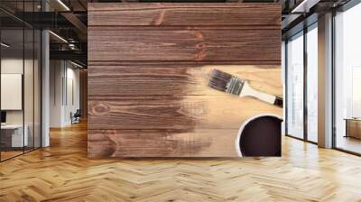 Process of painting the wood boards with the brush and the brown Wall mural