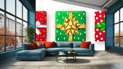 Gift box with green, red, golden ribbon and bow, top view. Wall mural