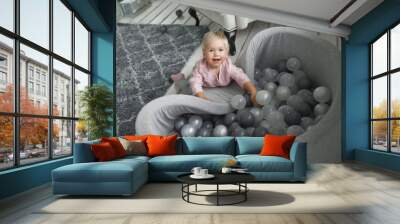 The baby is playing in the pool with balls 2029. Wall mural